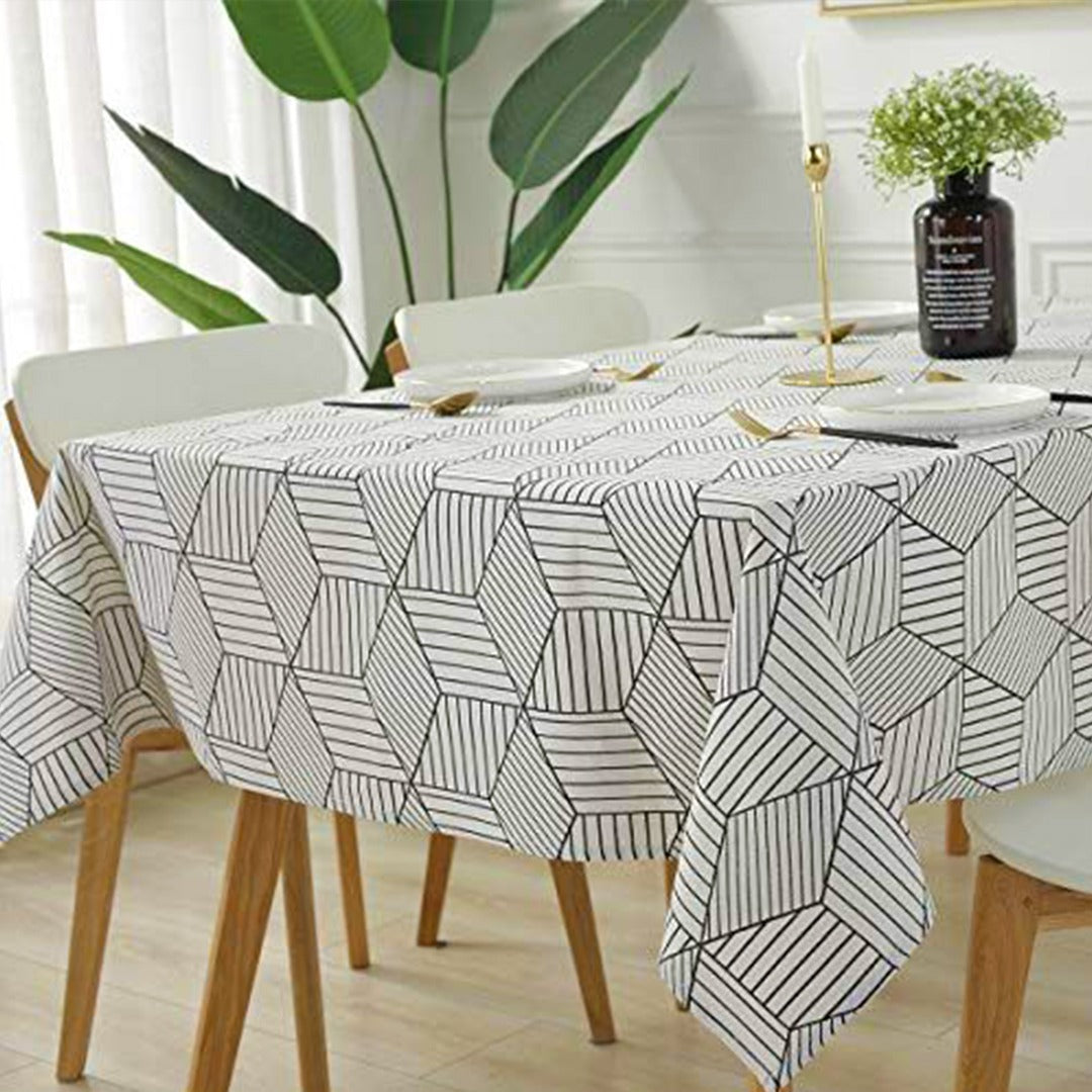 White tablecloth with fine grey geometric line patterns.