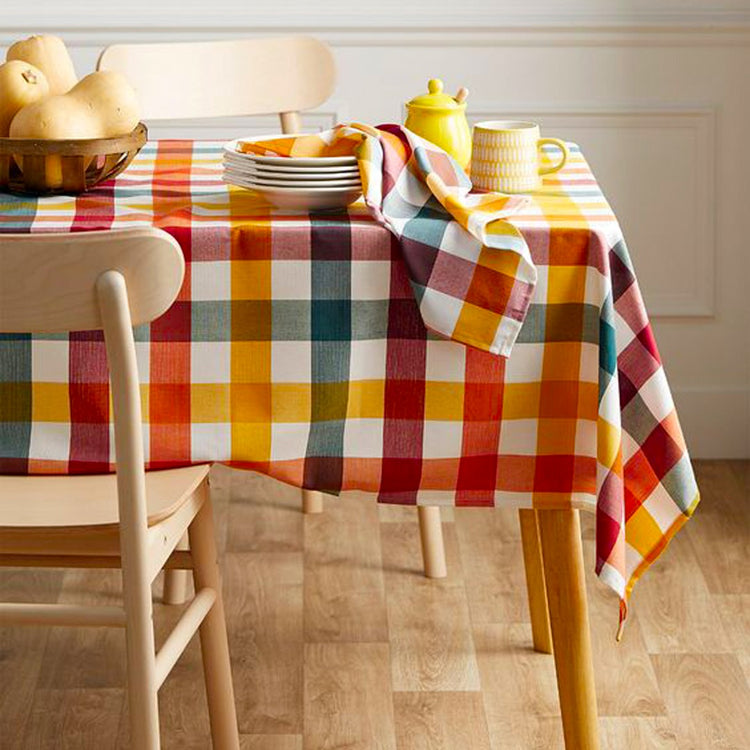 Multicoloured checked tablecloth in red, yellow, blue and white.