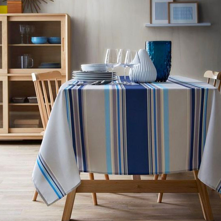 Blue, grey and beige striped tablecloth on a dining table.