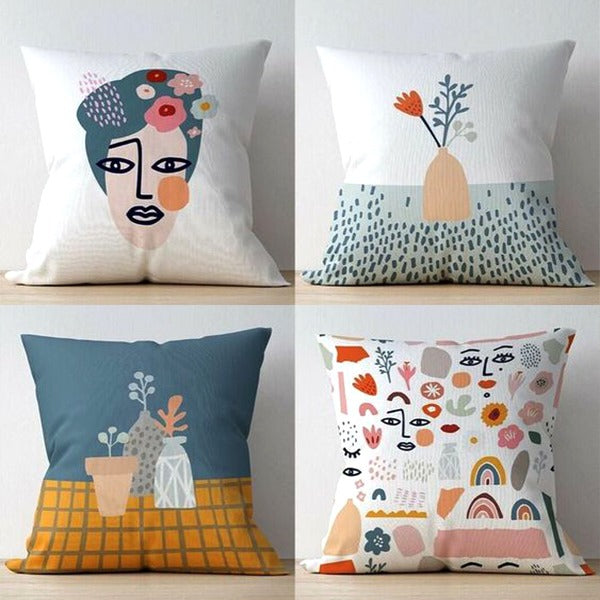 Four cushion covers with abstract face, vase, flower and illustrated motif designs.