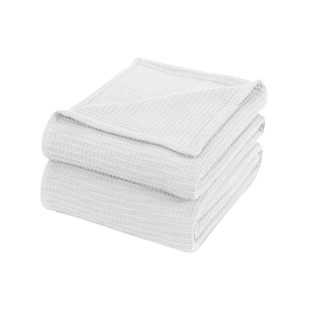 Folded white waffle-weave cotton thermal blanket.