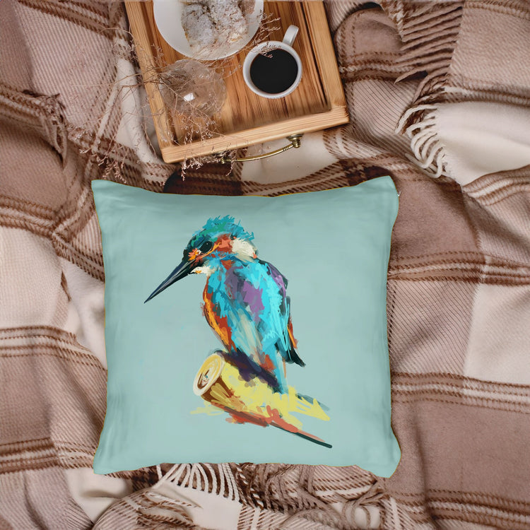 Turquoise cushion cover with a colourful kingfisher perched on a branch.