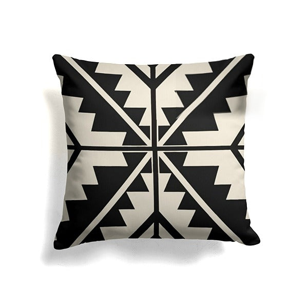 Black and cream cushion cover with a symmetrical angular cross pattern.