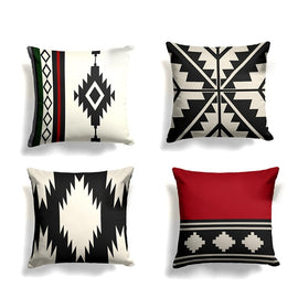 Four black, cream and red cushion covers with bold geometric motifs.