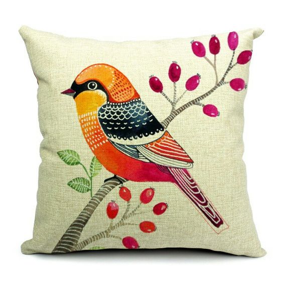 Cream cushion cover with an orange bird beside a branch of red berries.