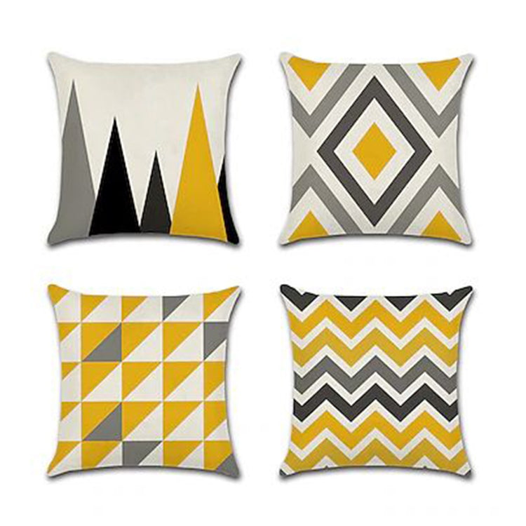 Four mustard, grey and cream cushion covers with triangle, diamond and zigzag patterns.
