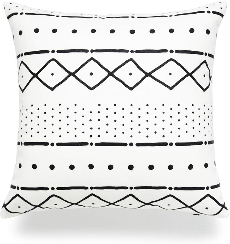 White cushion cover with horizontal black diamonds, dots and lines.