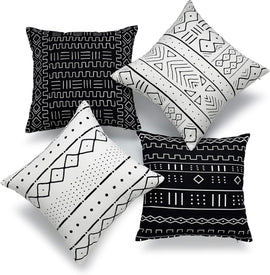 Four black and white cushion covers with hand-drawn geometric line patterns.