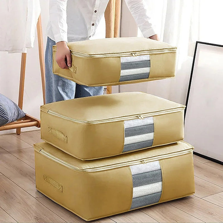 Mustard zippered clothes-storage bags stacked beside a person holding one bag.