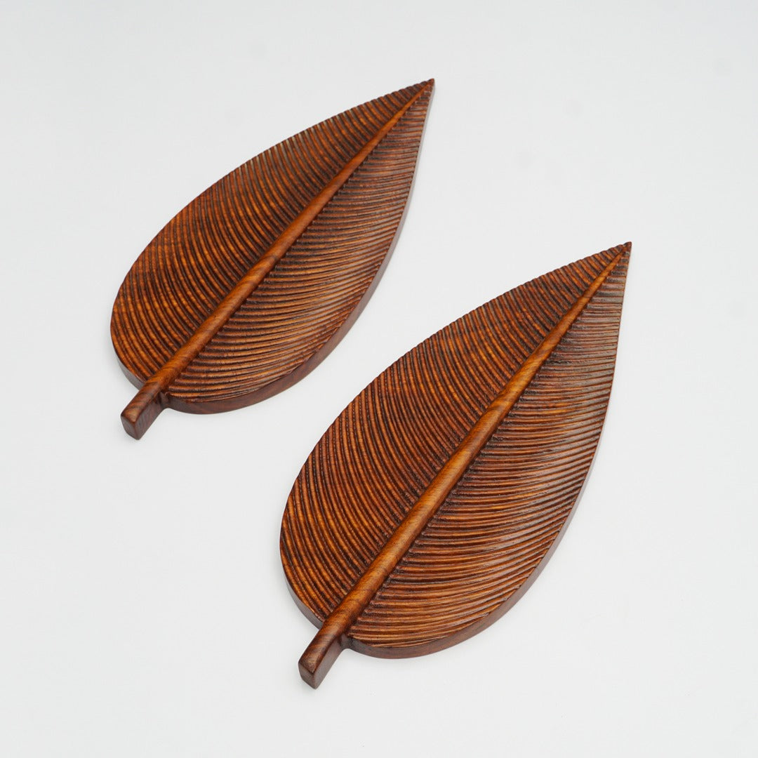 Two brown leaf-shaped trays shown at an angle