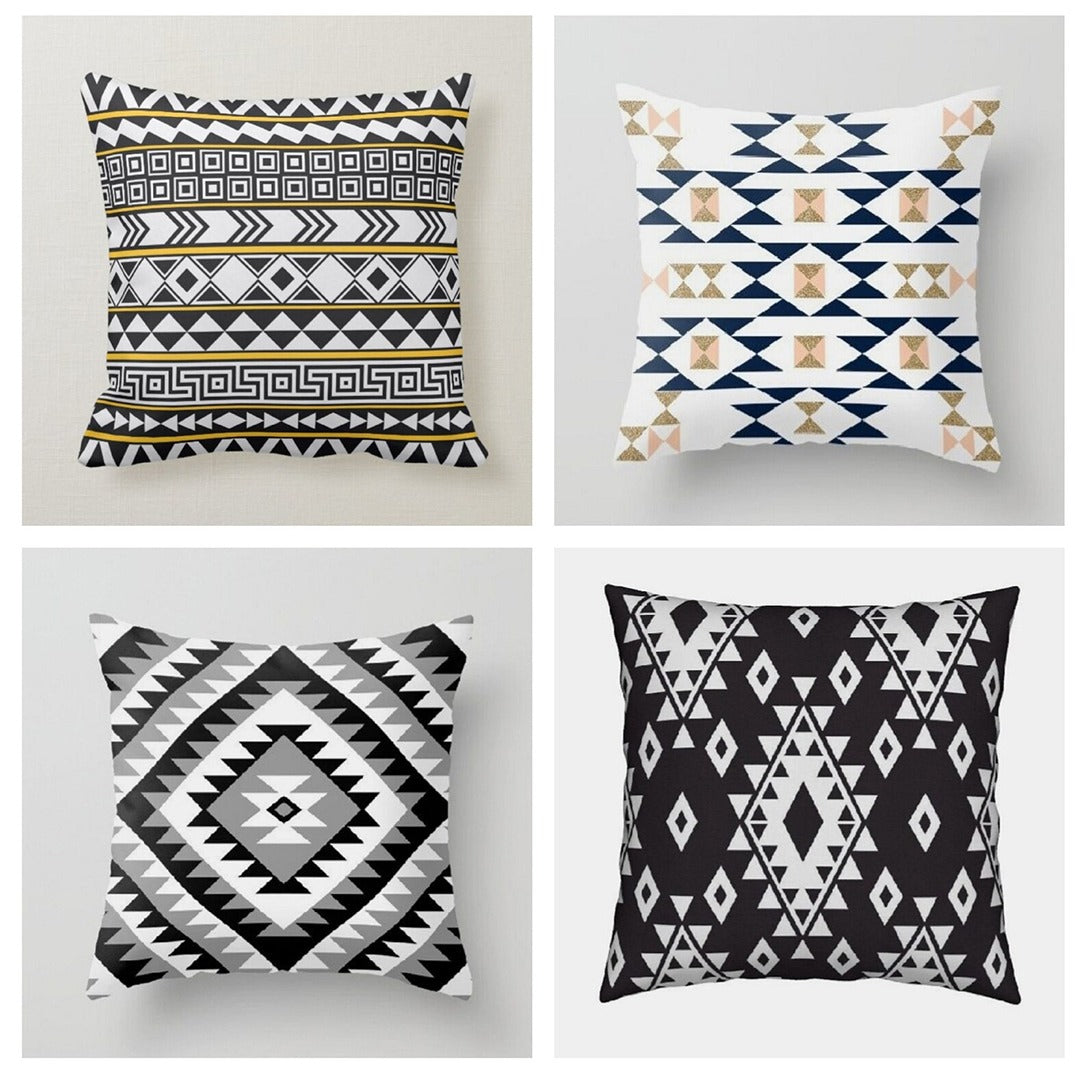 Four cushion covers with black, white, navy and gold coloured geometric patterns.