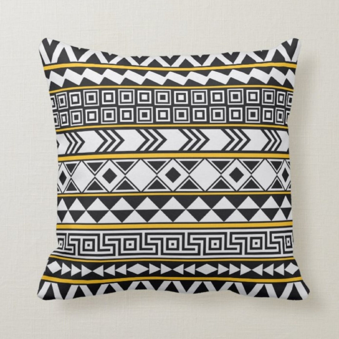 Cushion cover with narrow black, white and gold coloured geometric bands.