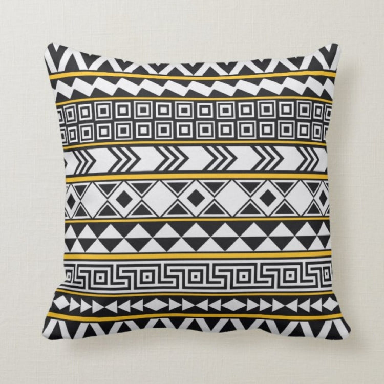 Cushion cover with narrow black, white and gold coloured geometric bands.
