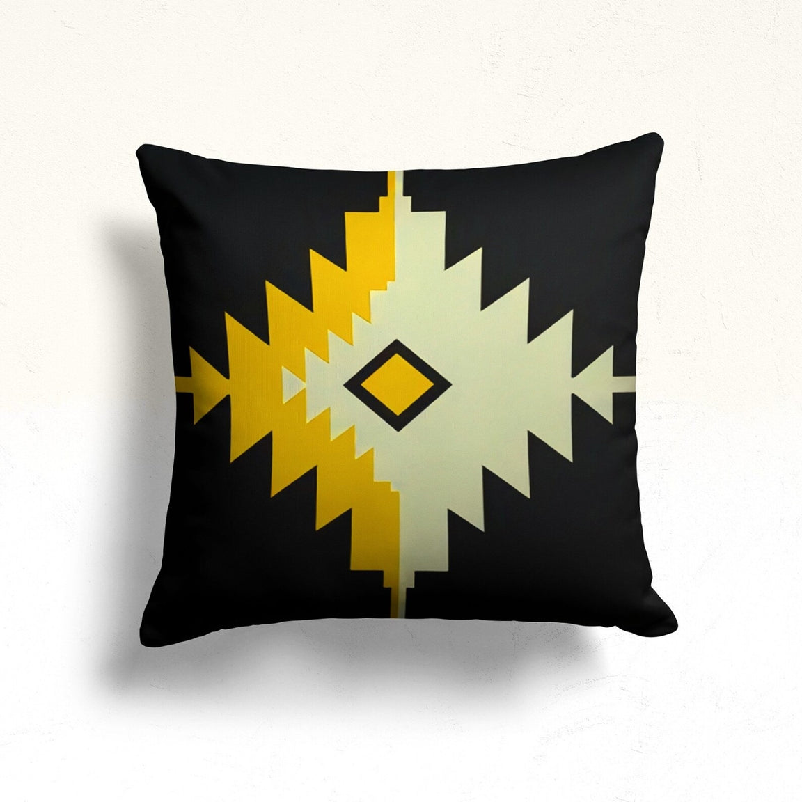 Black cushion cover with a large mustard and cream stepped diamond.