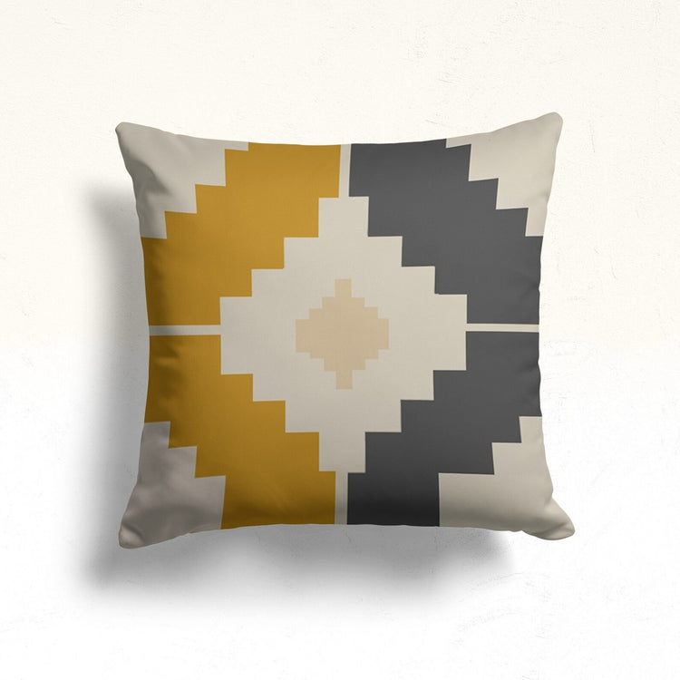 Cushion cover with a cream stepped diamond over mustard and grey sections.