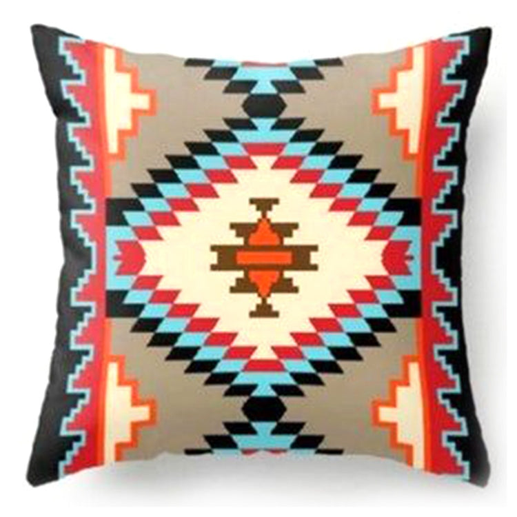 Cushion cover with a large cream diamond surrounded by rust, teal and black stepped shapes.