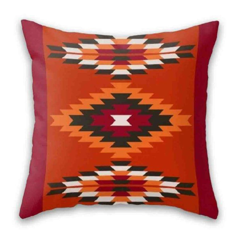 Rust cushion cover with a central stepped diamond and patterned bands at top and bottom.
