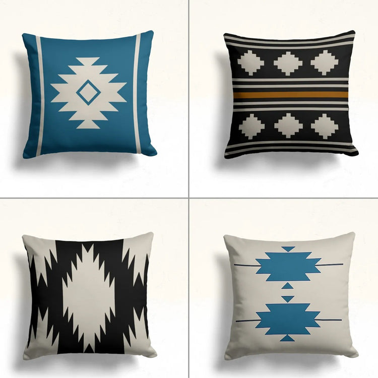 Four teal, black and cream cushion covers with stepped diamond motifs.