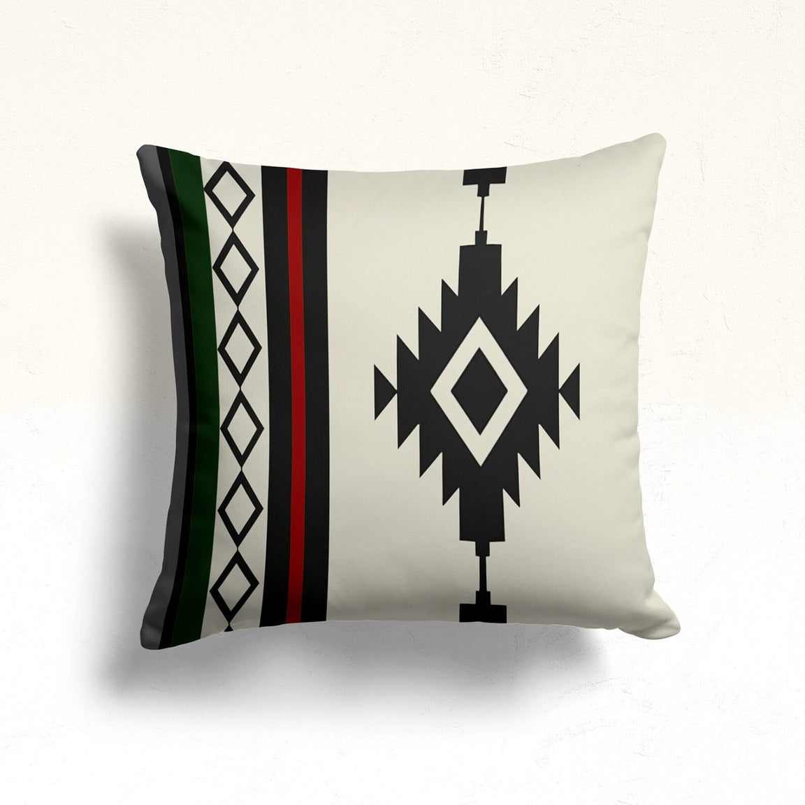 Cream cushion cover with a black stepped diamond and green and red side stripes.