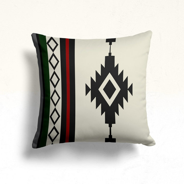 Cream cushion cover with a black stepped diamond and green and red side stripes.