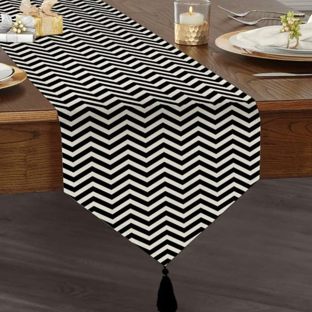Black and white narrow-chevron table runner with a tasselled end.