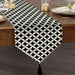 Black and white geometric lattice table runner with a tasselled end.