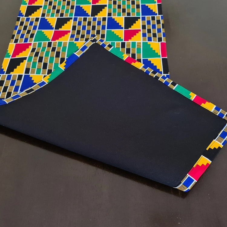 Multicoloured geometric table-runner fabric turned back to reveal its plain reverse.