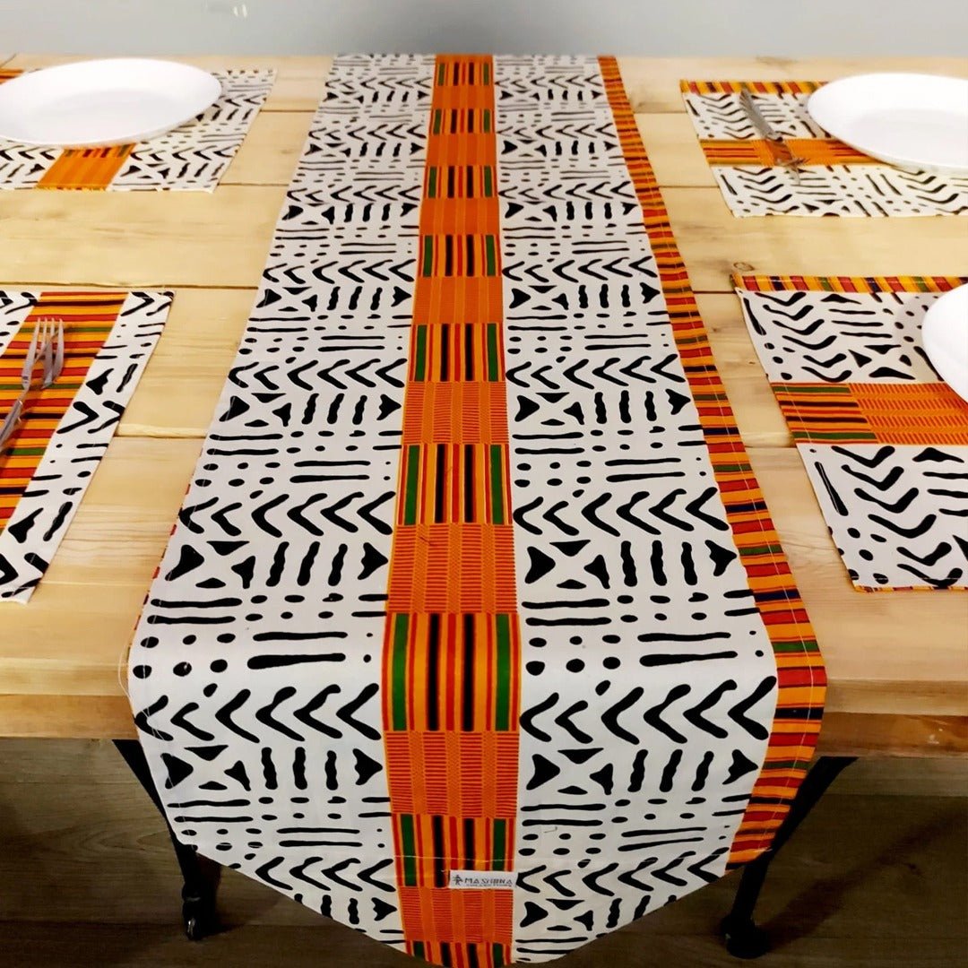 Black and white geometric table runner with an orange centre stripe and matching placemats.