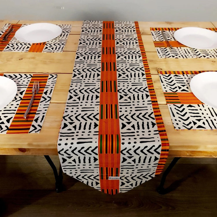 Black and white geometric table runner with an orange centre stripe and matching placemats.