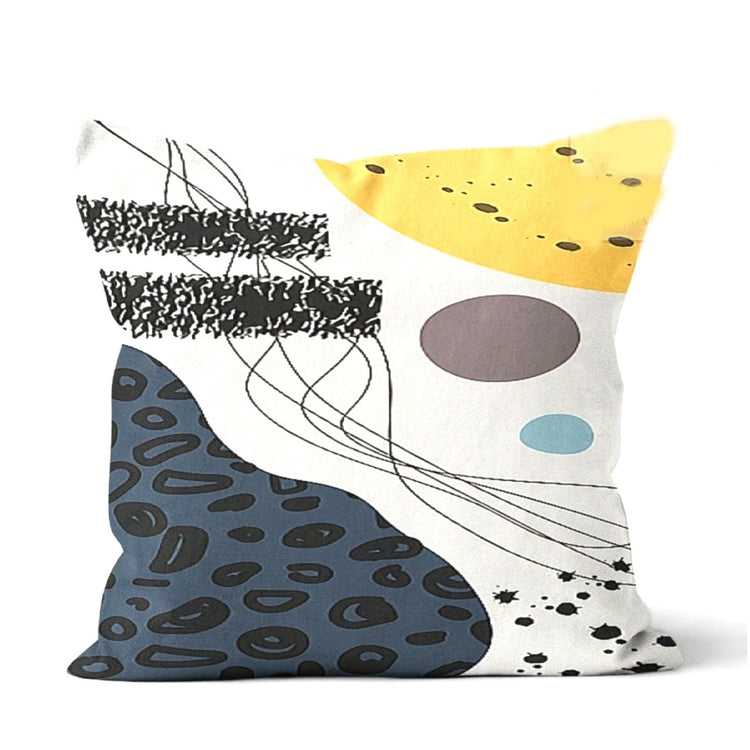 Cushion cover with navy, yellow and grey abstract panels, black spots and looping lines.