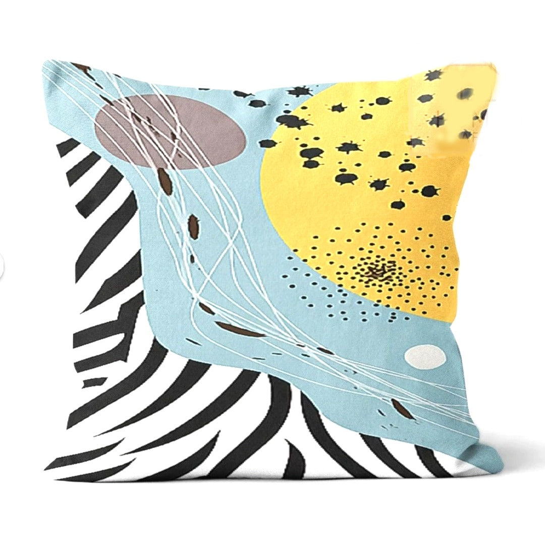 Cushion cover with pale blue, yellow and black striped abstract shapes.
