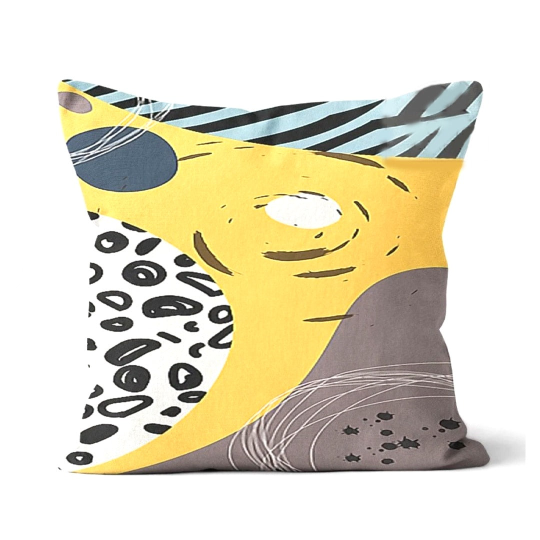 Cushion cover with a yellow centre and black striped, spotted and grey abstract panels.
