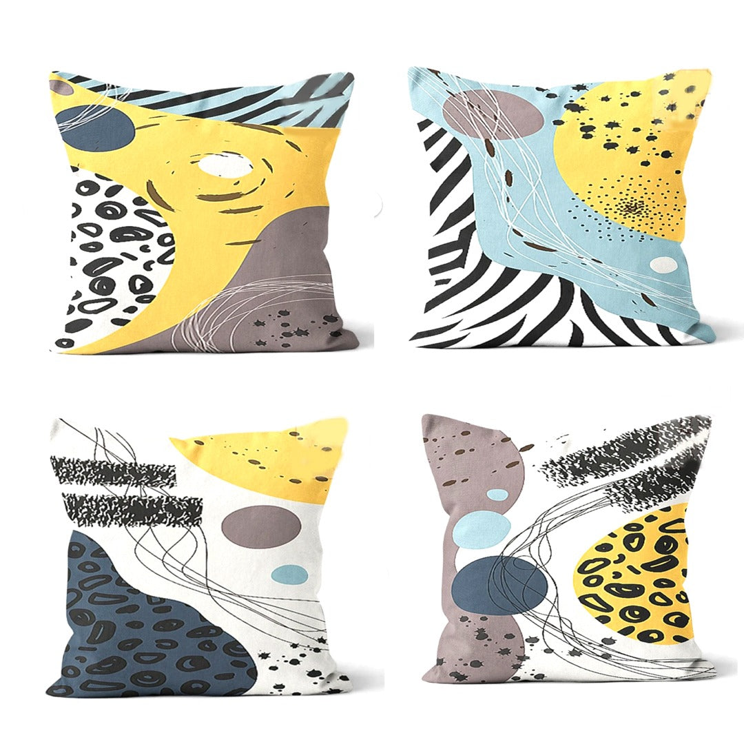 Four cushion covers with yellow, pale blue, grey and black abstract animal-print panels.