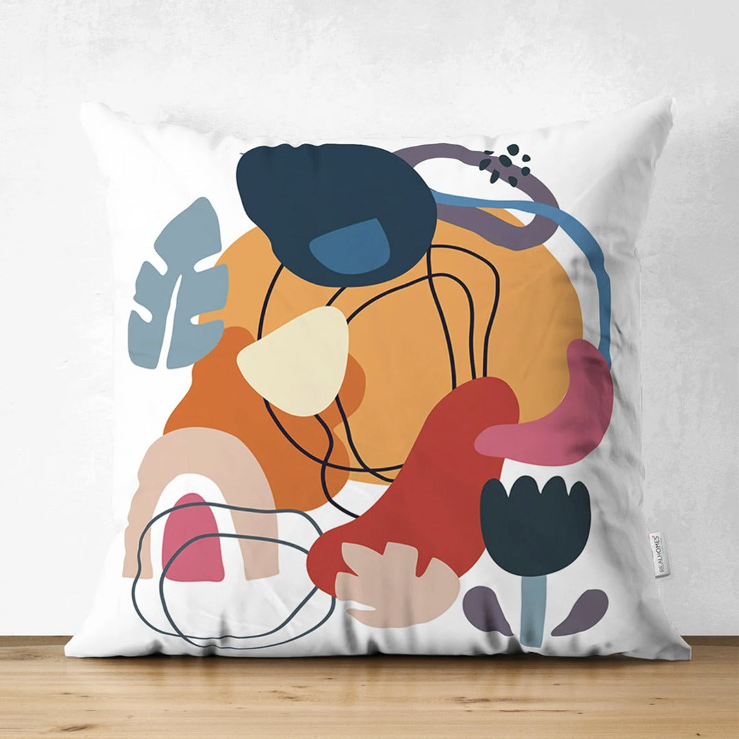 Cream cushion cover with layered mustard, navy, pink and rust shapes and fine black lines.