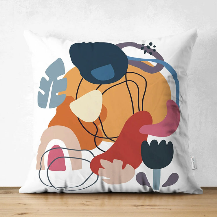 Cream cushion cover with layered mustard, navy, pink and rust shapes and fine black lines.
