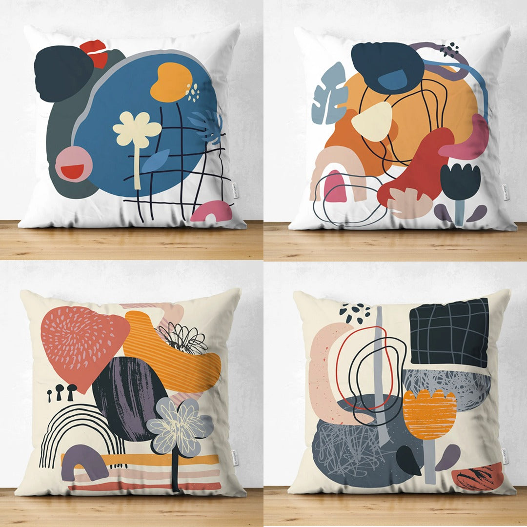 Four cream cushion covers with colourful abstract shapes and fine line drawings.