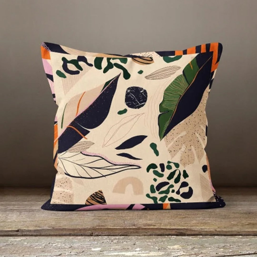 Cream cushion cover with scattered navy, rust and green leaves and delicate sprigs.