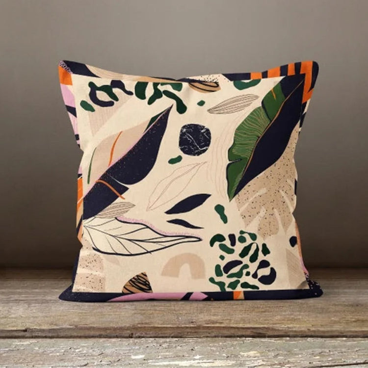 Cream cushion cover with scattered navy, rust and green leaves and delicate sprigs.