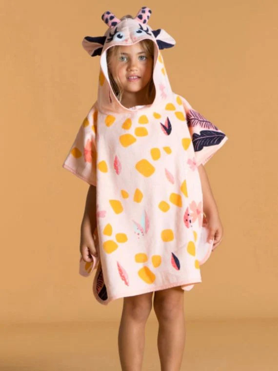 Child wearing the giraffe hood of a peach patterned towel poncho.