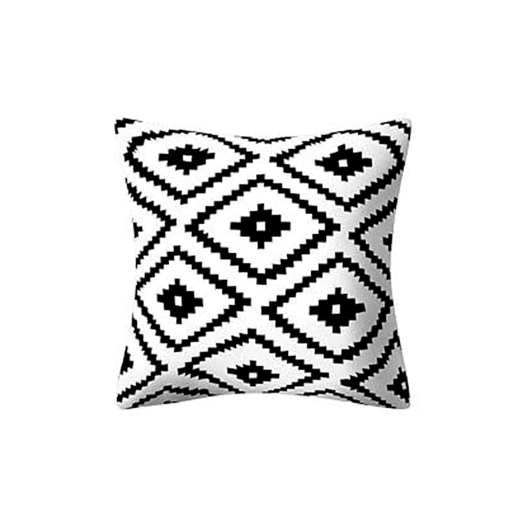 White cushion cover with large repeating black stepped diamonds.