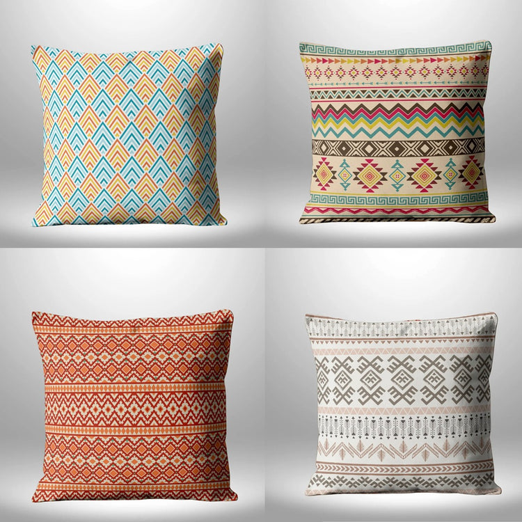 Four cushion covers with multicolored chevrons, diamonds and geometric bands in a two-by-two grid.