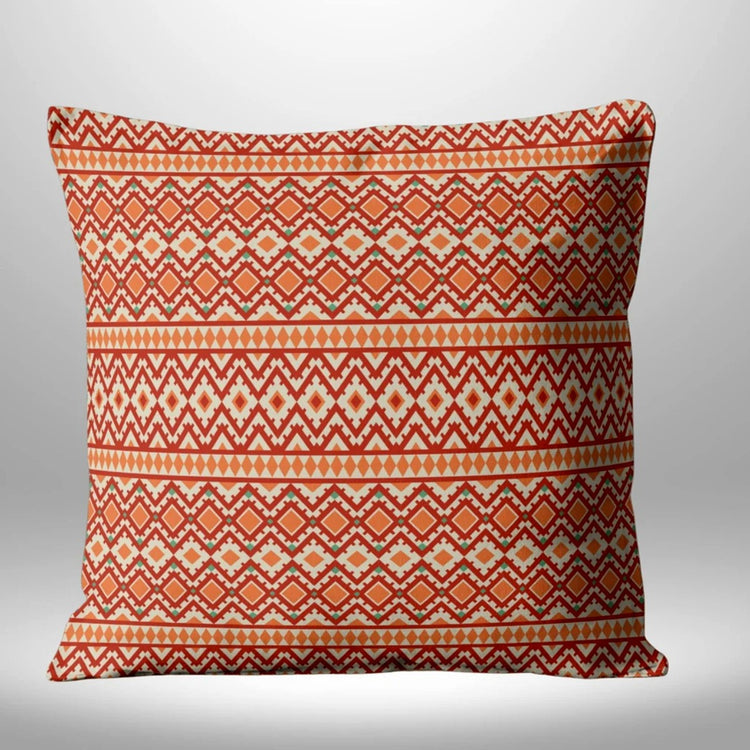 Red and orange cushion cover with cream diamond and zigzag patterns in horizontal bands.