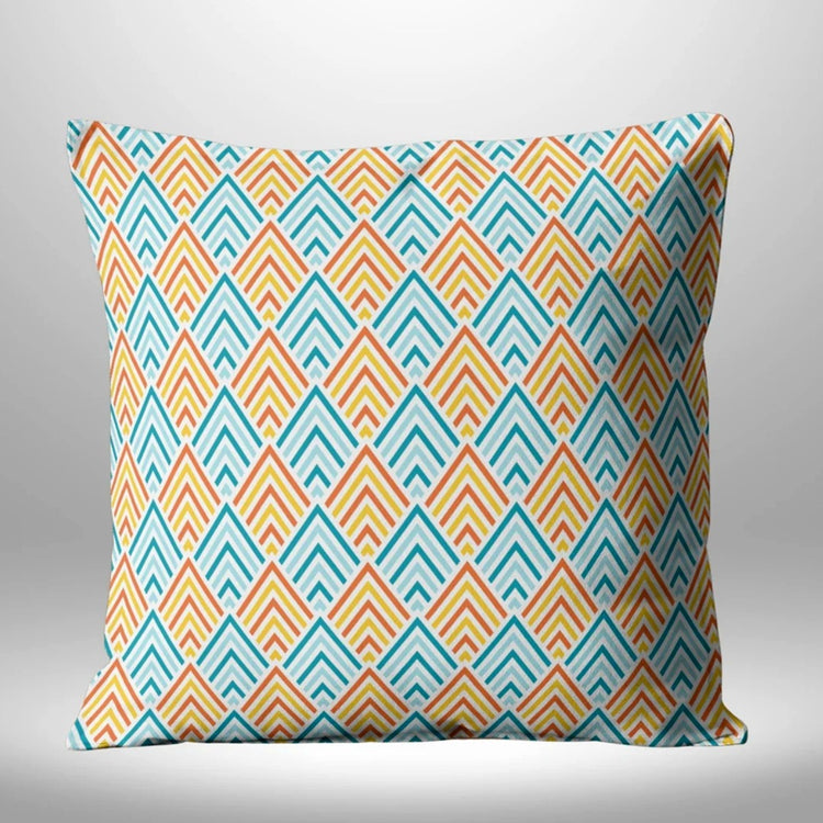 Cream cushion cover with repeating turquoise, yellow and red chevrons.