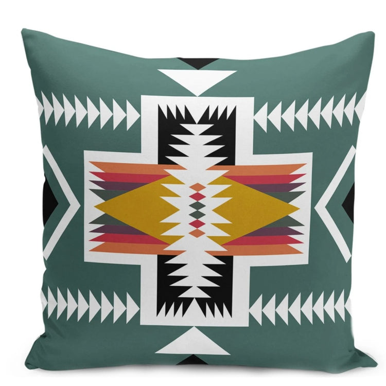 Green cushion cover with a white geometric cross and rust, yellow and black details.
