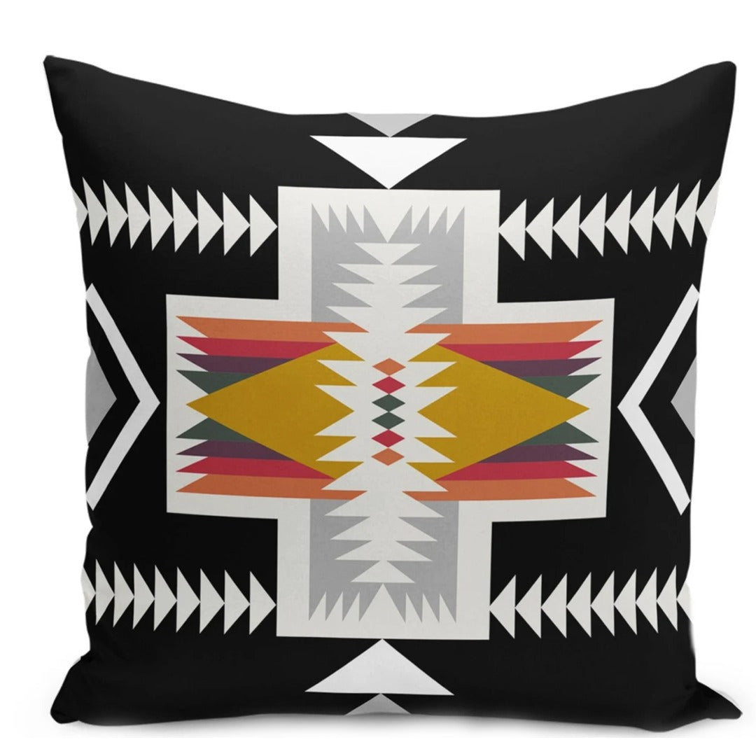 Black cushion cover with a cream geometric cross and rust, yellow and grey details.