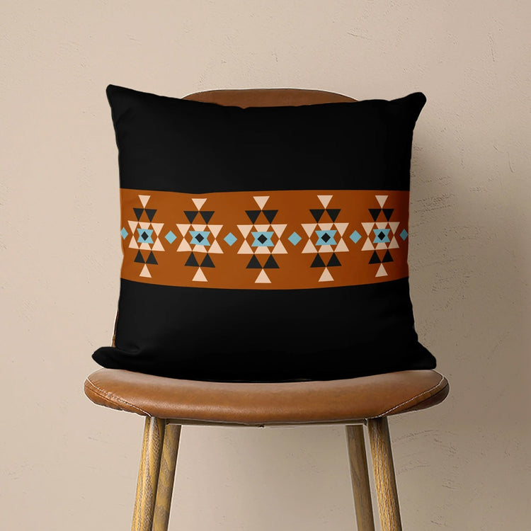 Black cushion cover with an orange horizontal band of small geometric motifs.