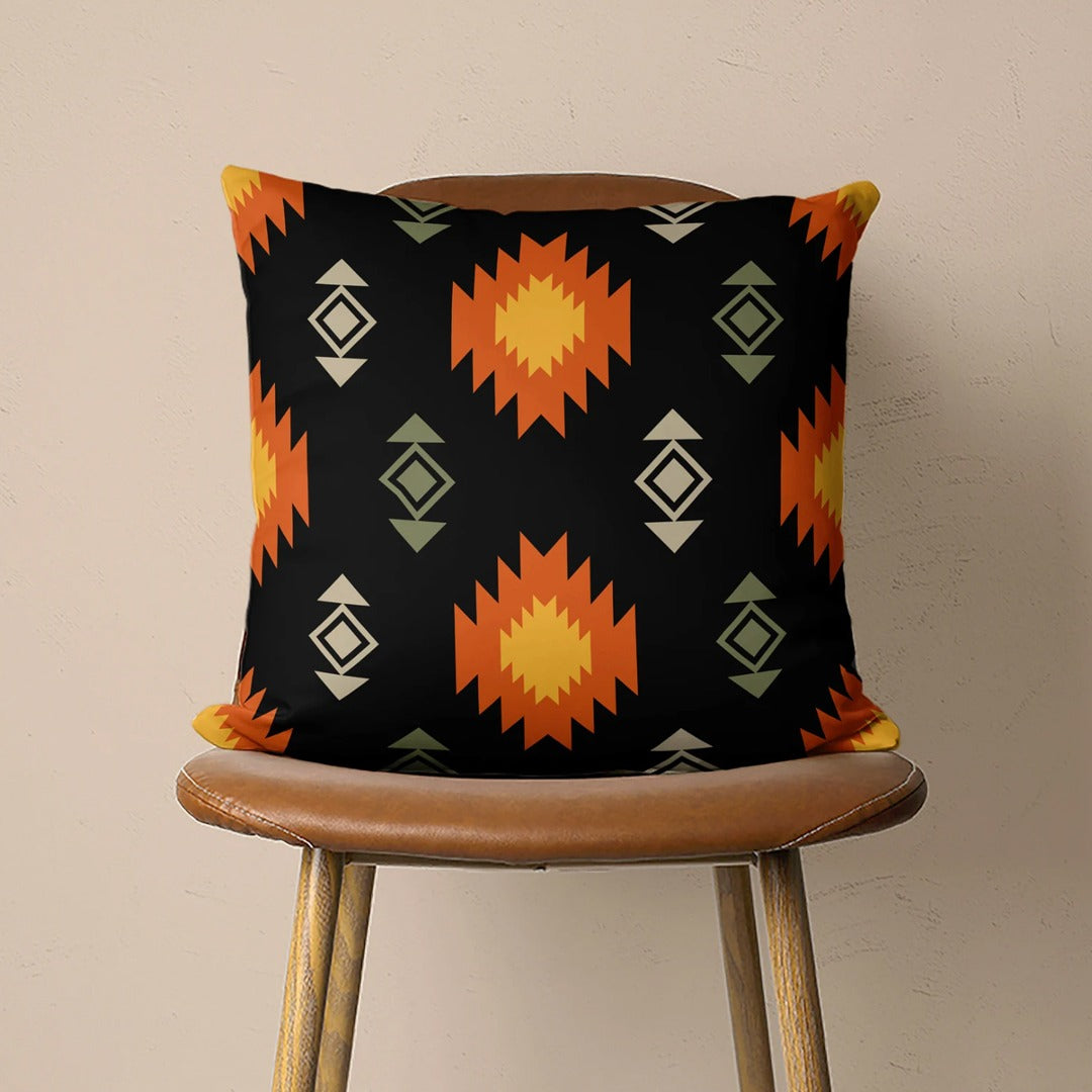 Black cushion cover with orange stepped diamonds and small beige motifs.
