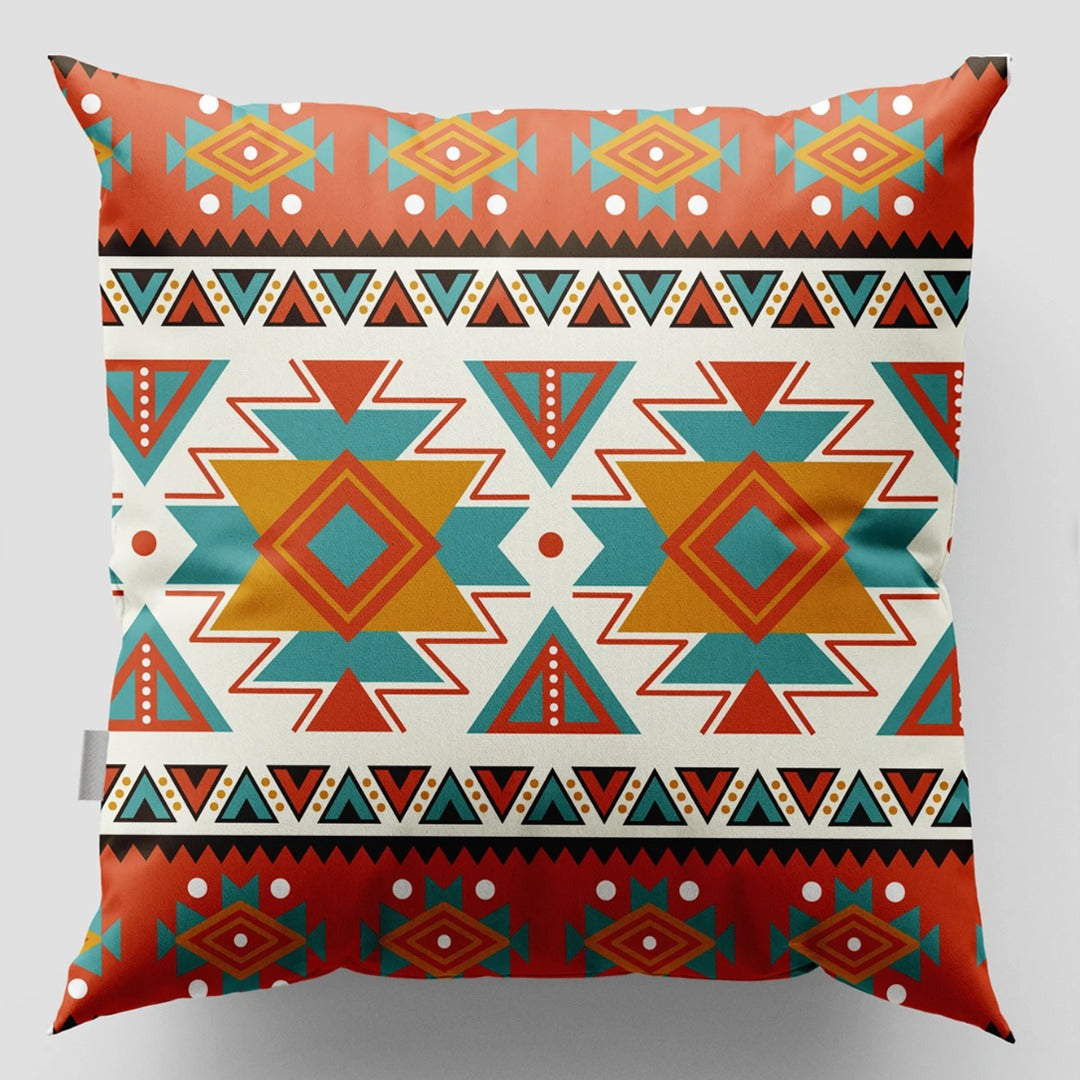 Cushion cover with two orange and teal geometric medallions and patterned rust borders.