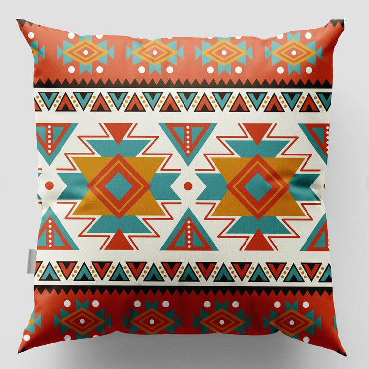 Cushion cover with two orange and teal geometric medallions and patterned rust borders.