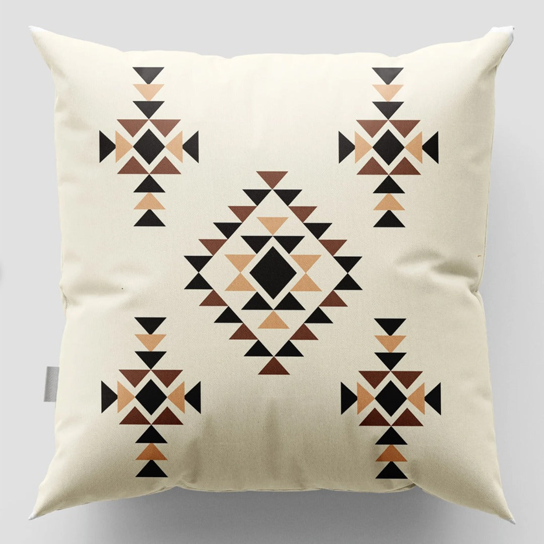 Cream cushion cover with brown and black diamonds and small geometric motifs.